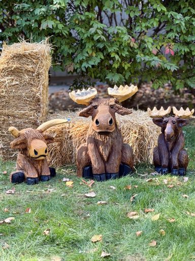Moose and Highland cow carvings
