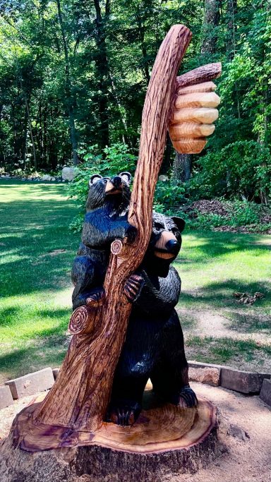 Momma bear and cub carved from an oak stump, close front view