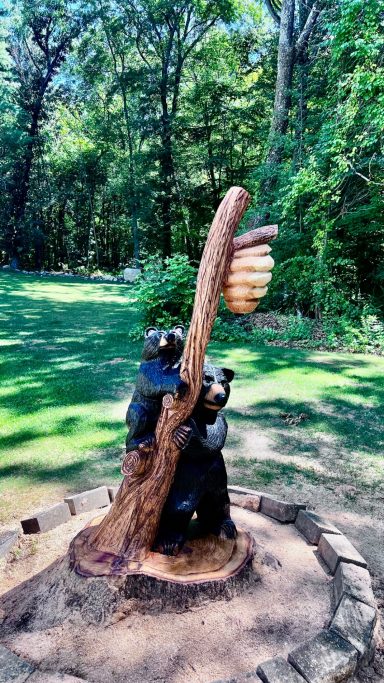 Momma bear and cub carved from an oak stump, full wide view